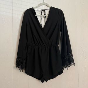 Homage black long sleeve romper with lace detailing on cuffs